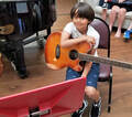 Little boy plays guitar, guitar lessons Chesapeake